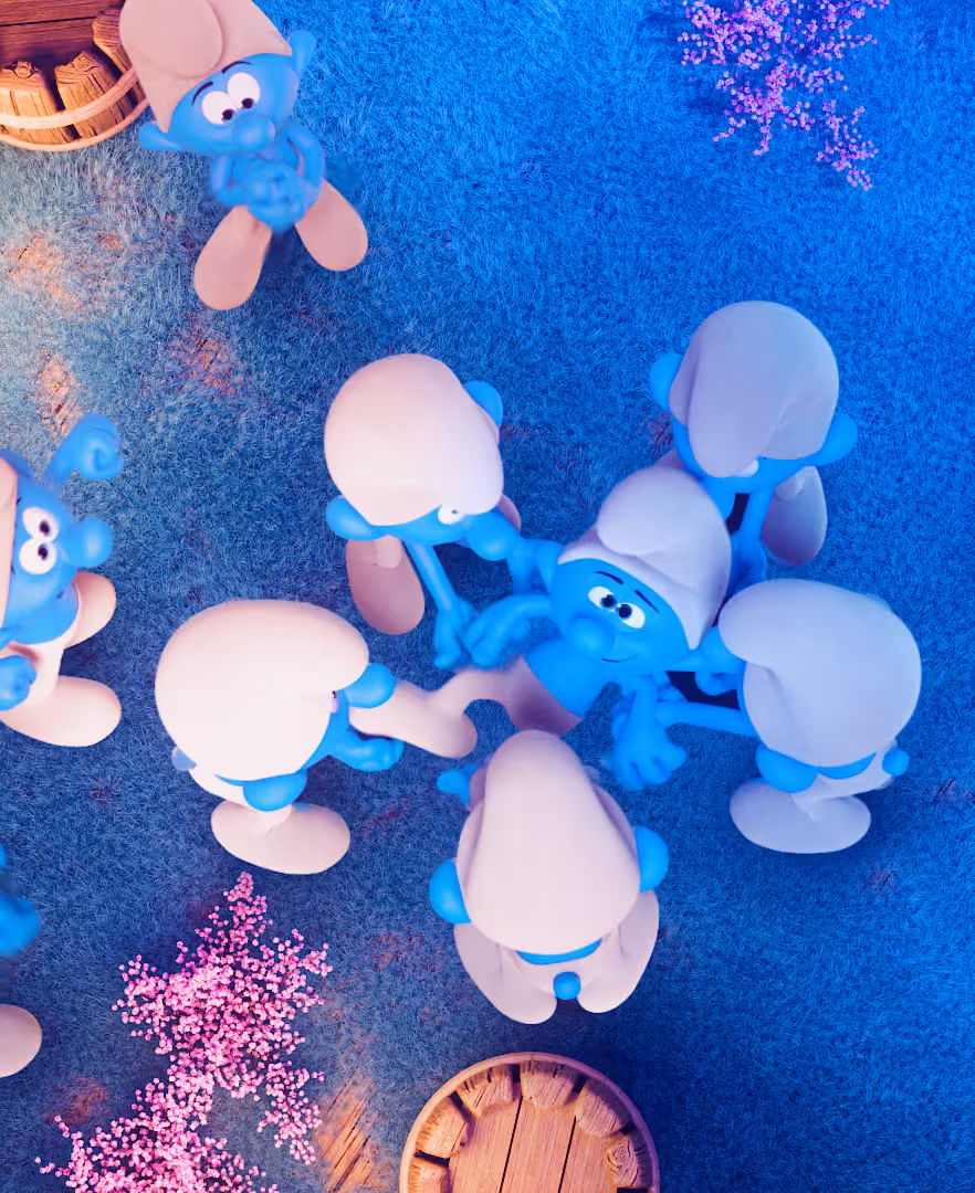 NEA Studio 3D animation - aerial view of Smurf characters gathered around wooden floor for Ruby Rose Smurfs beauty collection